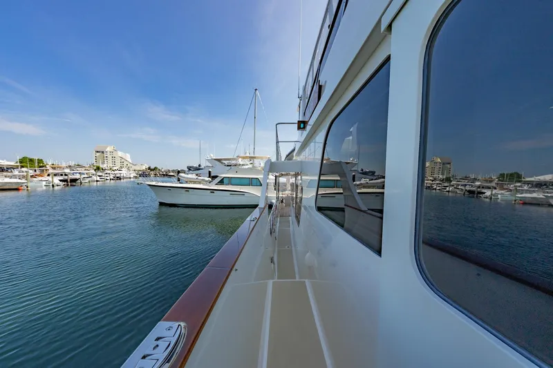 Dash Yacht Photos Pics 2016 Grand Banks 72 Aleutian RP yacht docked in a marina, clear blue sky.