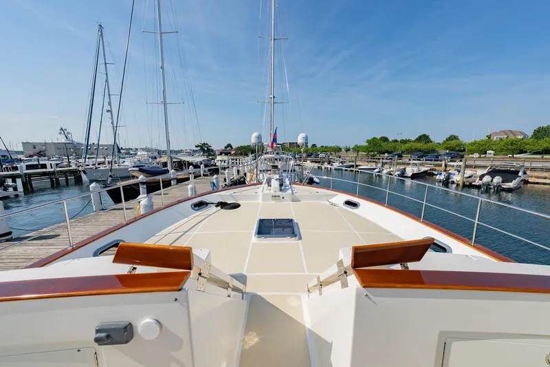 Dash Yacht Photos Pics 2016 Grand Banks 72 Aleutian RP yacht docked at a marina under clear blue skies.