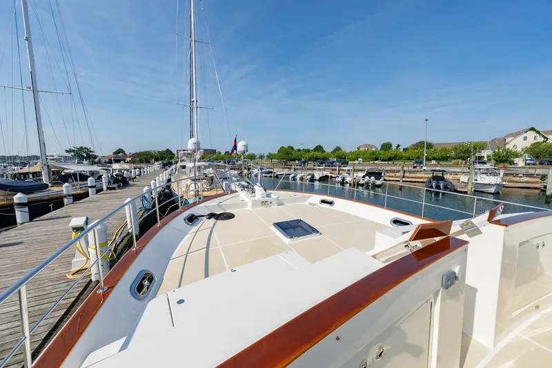 Dash Yacht Photos Pics 2016 Grand Banks 72 Aleutian RP yacht docked at a marina under clear blue skies.