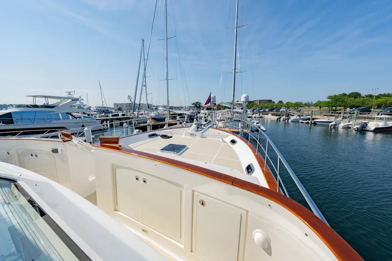 Dash Yacht Photos Pics 2016 Grand Banks 72 Aleutian RP yacht docked at a marina under clear blue skies.