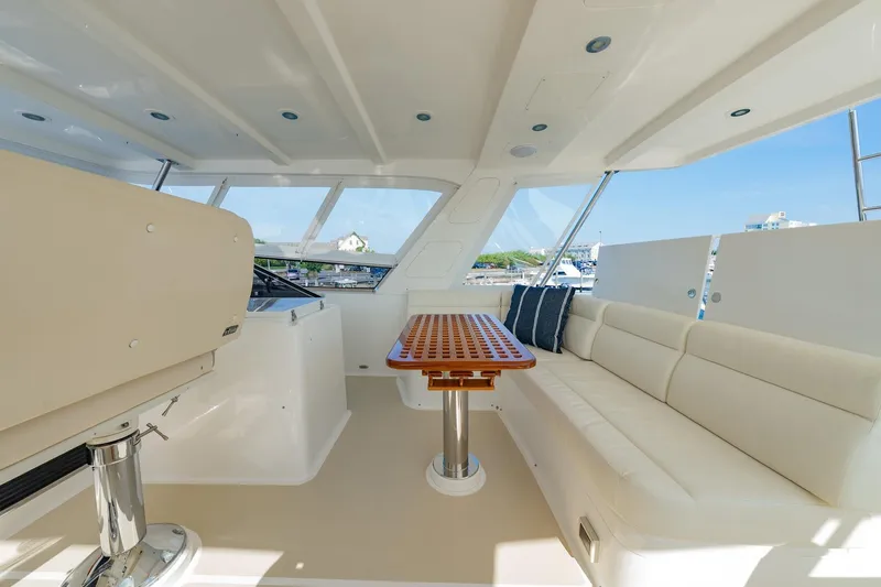 Dash Yacht Photos Pics Luxurious interior of 2016 Grand Banks 72 Aleutian RP yacht with seating and table.