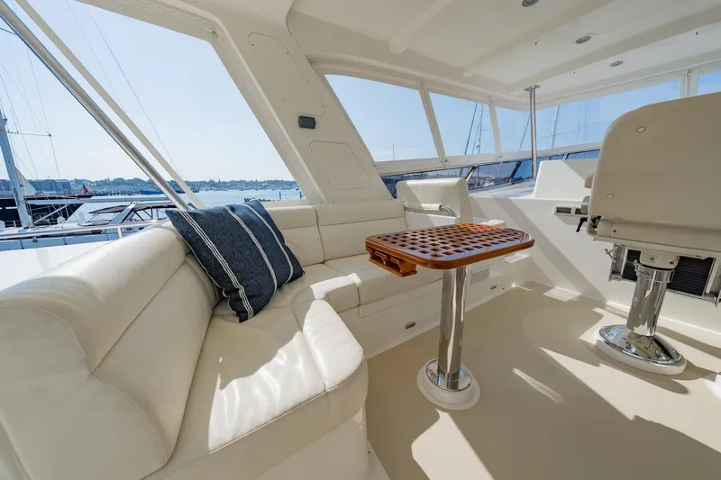 Dash Yacht Photos Pics Luxurious interior of 2016 Grand Banks 72 Aleutian RP yacht with plush seating and table.