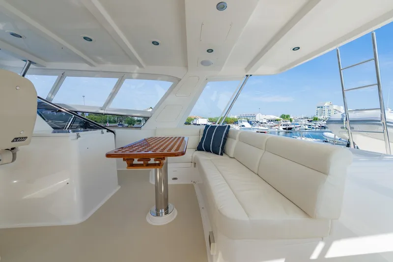 Dash Yacht Photos Pics Luxurious 2016 Grand Banks 72 Aleutian RP yacht interior with plush seating and marina view.