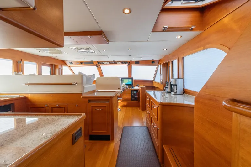 Dash Yacht Photos Pics Luxurious interior of 2016 Grand Banks 72 Aleutian RP yacht with wooden finishes.