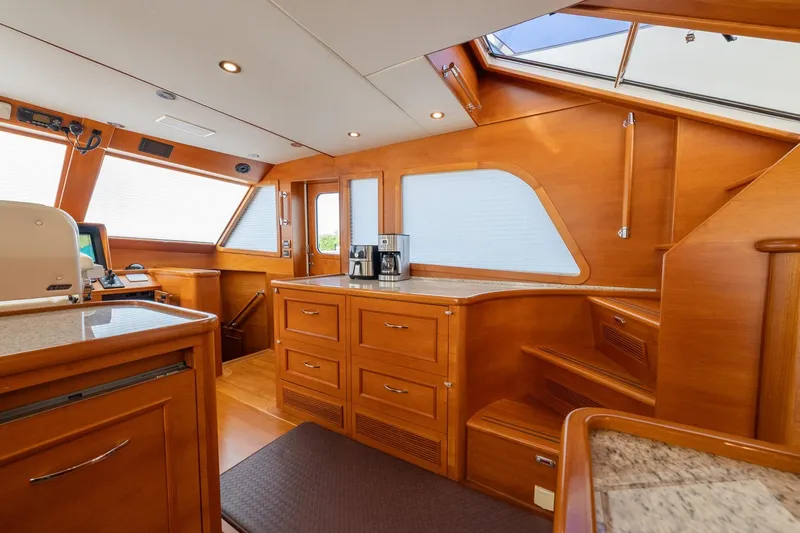 Dash Yacht Photos Pics Luxurious interior of 2016 Grand Banks 72 Aleutian RP yacht with wooden cabinetry and modern amenities.
