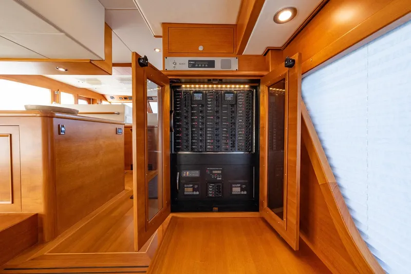 Dash Yacht Photos Pics Electrical panel inside 2016 Grand Banks 72 Aleutian RP yacht, featuring elegant wood interior.