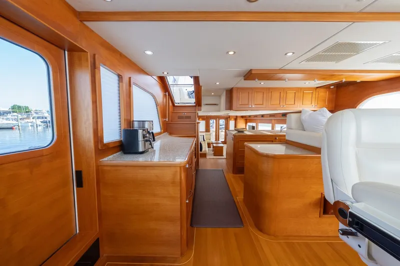 Dash Yacht Photos Pics Luxurious interior of 2016 Grand Banks 72 Aleutian RP yacht with elegant wood finishes.