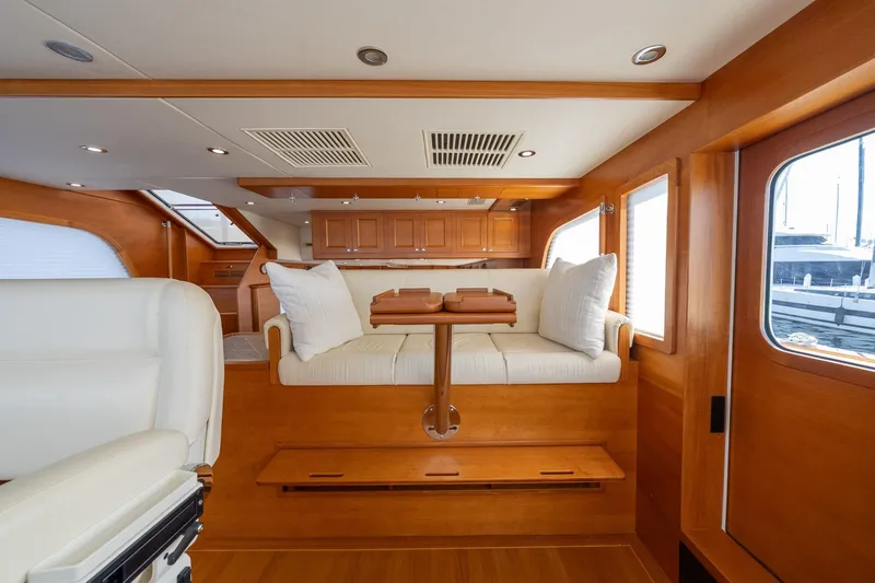 Dash Yacht Photos Pics Luxurious interior of 2016 Grand Banks 72 Aleutian RP yacht with wooden finishes.