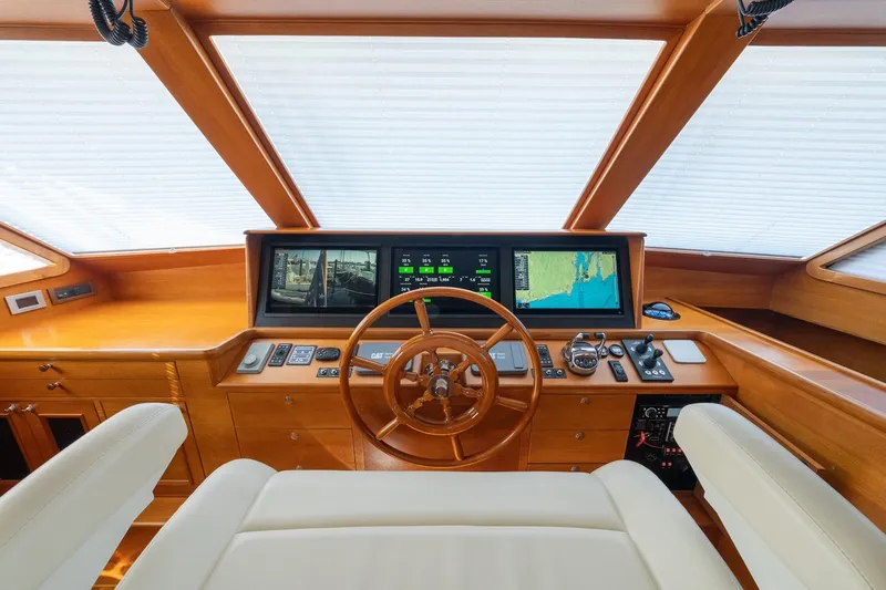 Dash Yacht Photos Pics Helm of 2016 Grand Banks 72 Aleutian RP yacht with navigation screens and wooden wheel.