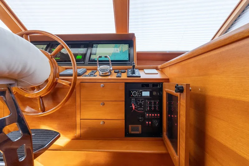 Dash Yacht Photos Pics Helm of 2016 Grand Banks 72 Aleutian RP yacht with wooden steering wheel and navigation controls.