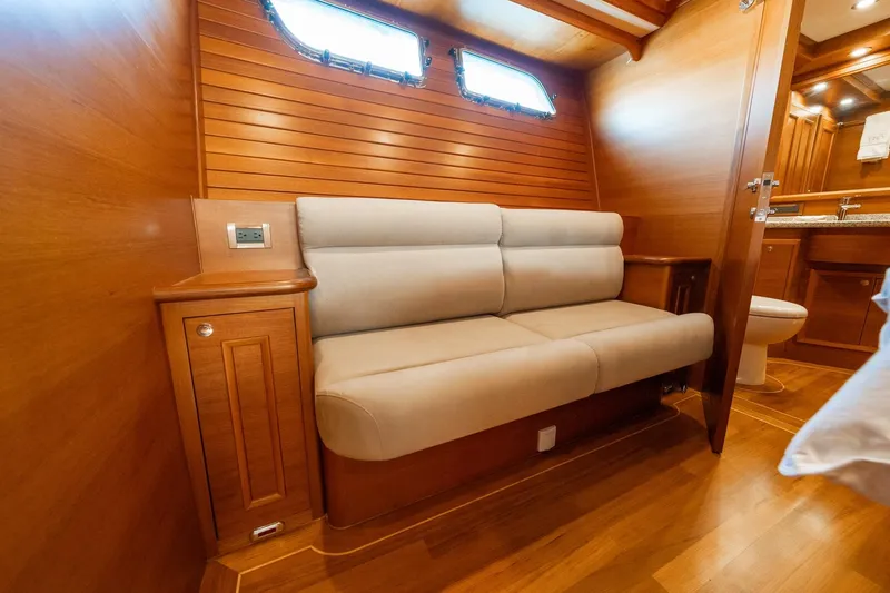 Dash Yacht Photos Pics Luxurious interior of 2016 Grand Banks 72 Aleutian RP yacht with wooden paneling and plush seating.