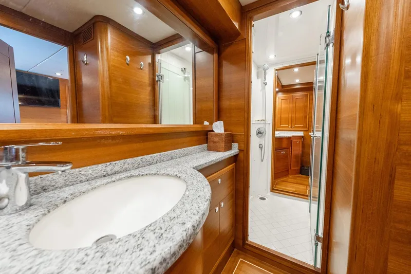 Dash Yacht Photos Pics Luxurious bathroom interior of 2016 Grand Banks 72 Aleutian RP yacht with wooden accents.