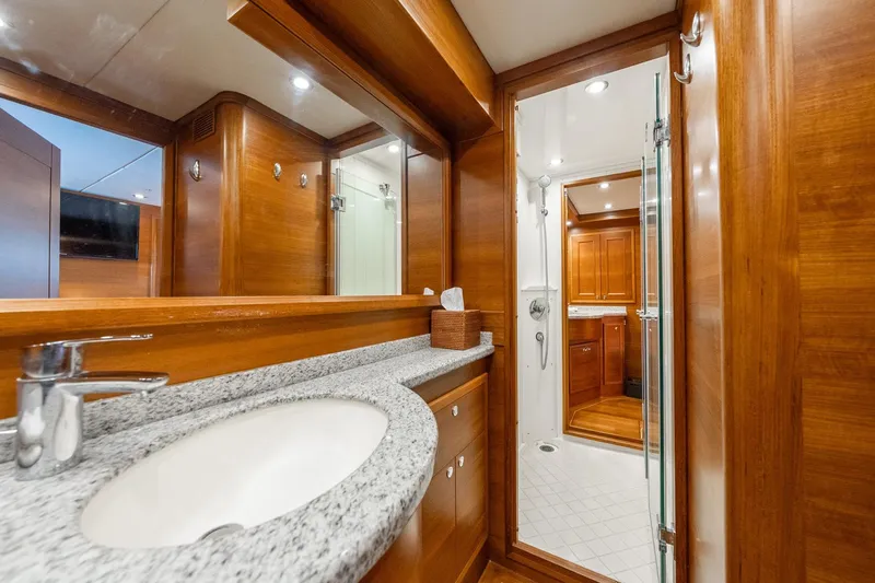 Dash Yacht Photos Pics Luxurious bathroom interior on 2016 Grand Banks 72 Aleutian RP yacht, featuring wood finishes.