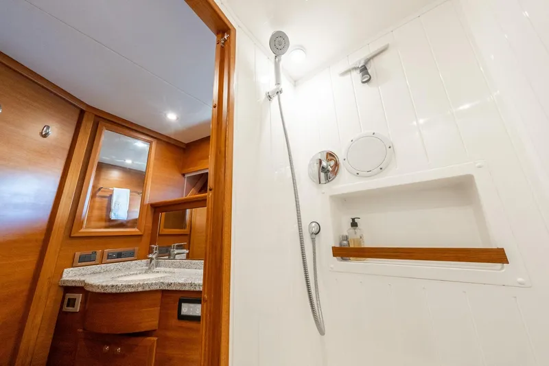 Dash Yacht Photos Pics Luxurious bathroom interior of 2016 Grand Banks 72 Aleutian RP yacht, featuring wood accents and modern fixtures.