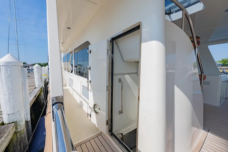 Dash Yacht Photos Pics 2016 Grand Banks 72 Aleutian RP yacht side deck with open hatch and marina view.