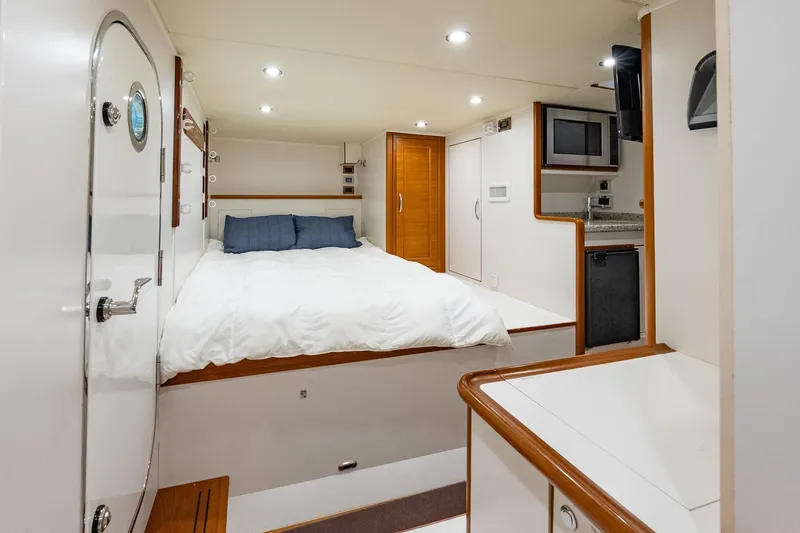 Dash Yacht Photos Pics Luxurious cabin interior of 2016 Grand Banks 72 Aleutian RP yacht with bed and kitchenette.