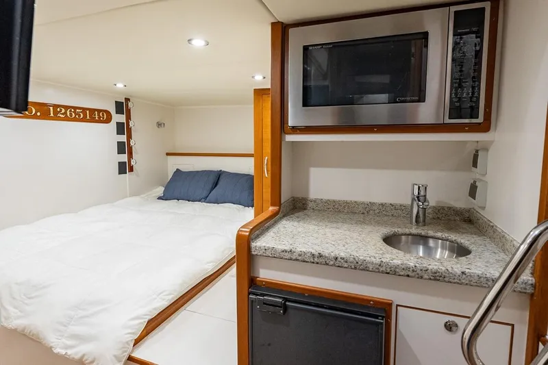 Dash Yacht Photos Pics Interior of 2016 Grand Banks 72 Aleutian RP with bed, kitchenette, and microwave.