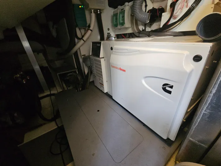 Yes Yacht Photos Pics Engine room of a 2016 Prestige 500 S yacht featuring a Cummins Onan generator.