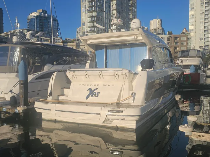 Yes Yacht Photos Pics Luxury 2016 Prestige 500 S yacht docked in urban marina setting.