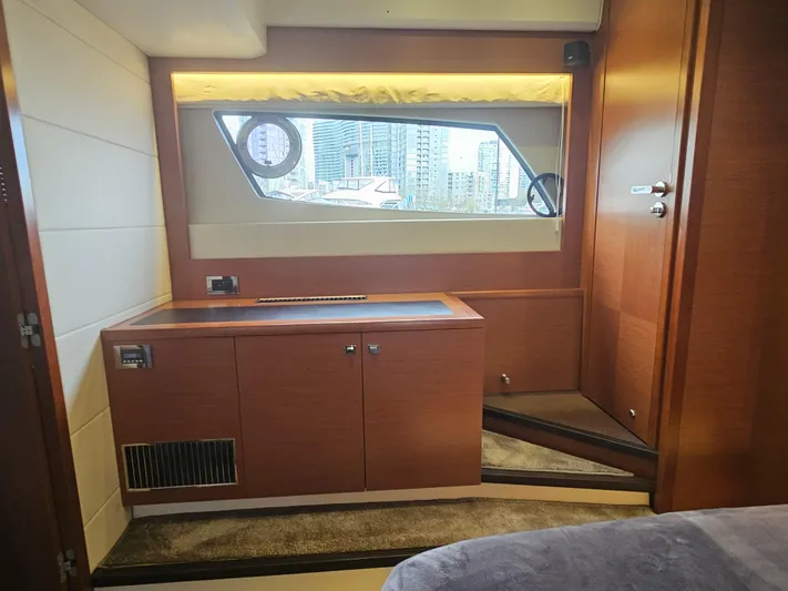 Yes Yacht Photos Pics Interior of 2016 Prestige 500 S yacht with wooden cabinetry and cityscape view.