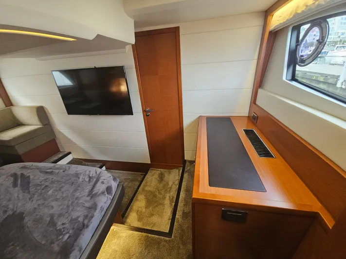 Yes Yacht Photos Pics Luxurious interior of a 2016 Prestige 500 S yacht with modern furnishings and a flat-screen TV.