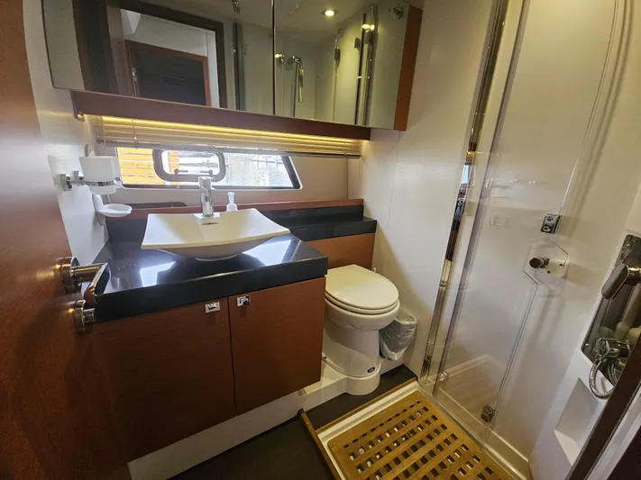 Yes Yacht Photos Pics Luxurious bathroom in 2016 Prestige 500 S yacht with modern fixtures and wooden accents.