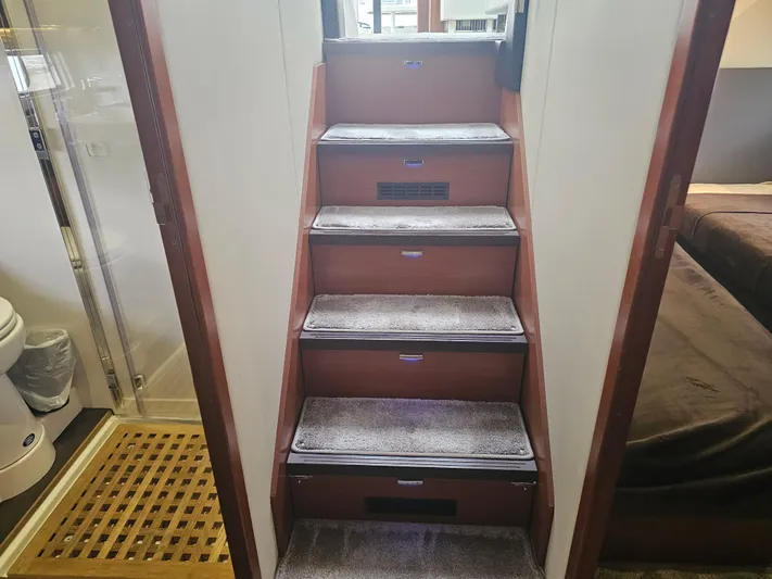 Yes Yacht Photos Pics Staircase inside 2016 Prestige 500 S yacht, leading to upper deck, with carpeted steps.