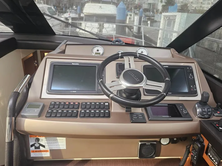 Yes Yacht Photos Pics Cockpit of 2016 Prestige 500 S yacht with steering wheel and navigation controls.