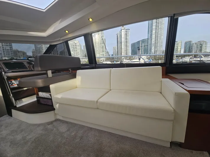 Yes Yacht Photos Pics Luxurious interior of 2016 Prestige 500 S yacht with cityscape view through large windows.