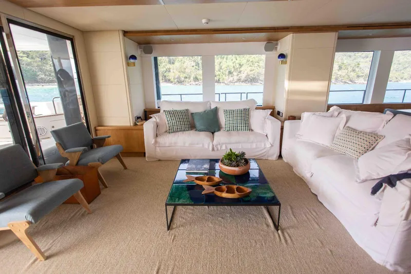  Yacht Photos Pics Luxurious interior of 2027 Inace Explora 90 yacht with elegant seating and scenic views.