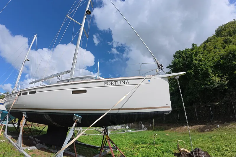 Fortuna Yacht Photos Pics 2016 Jeanneau Sun Odyssey 519 sailboat named "Fortuna" on land under a blue sky.