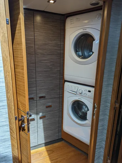 Sapphire Yacht Photos Pics 2020 Tiara Yachts F53 Flybridge laundry area with stacked washer and dryer.