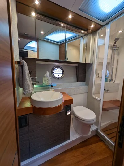 Sapphire Yacht Photos Pics Luxurious bathroom in 2020 Tiara Yachts F53 Flybridge with modern fixtures and wood accents.