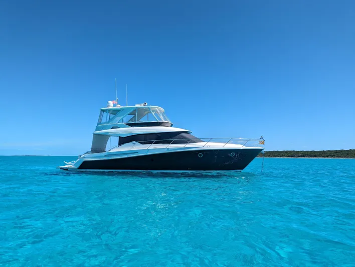 Sapphire Yacht Photos Pics 2020 Tiara Yachts F53 Flybridge on clear blue water under a bright sky.