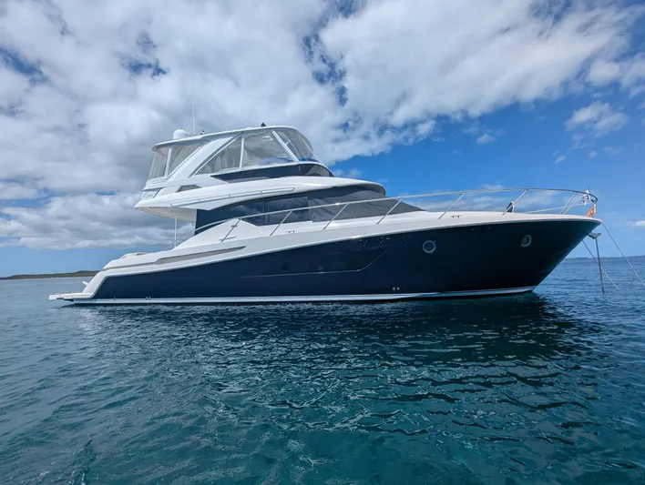 Sapphire Yacht Photos Pics 2020 Tiara Yachts F53 Flybridge on calm ocean under blue sky.