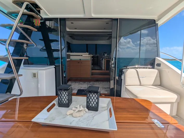 Sapphire Yacht Photos Pics 2020 Tiara Yachts F53 Flybridge interior with elegant seating and ocean view.