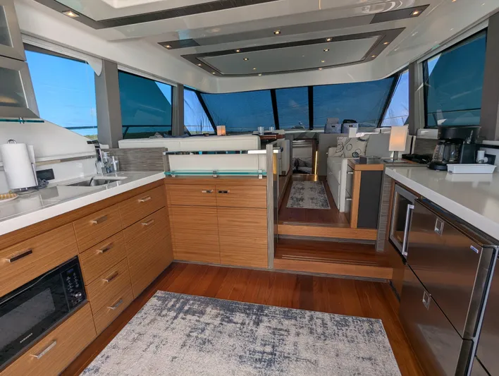 Sapphire Yacht Photos Pics Luxurious 2020 Tiara Yachts F53 Flybridge interior with modern kitchen and panoramic windows.