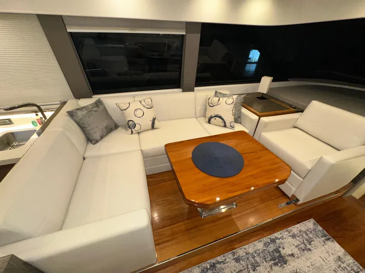 Sapphire Yacht Photos Pics Luxurious interior of 2020 Tiara Yachts F53 Flybridge with elegant seating and wooden table.