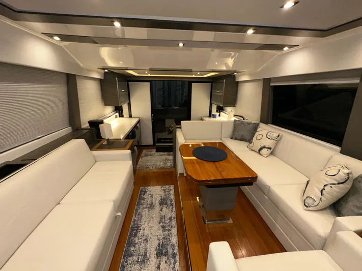 Sapphire Yacht Photos Pics Luxurious interior of 2020 Tiara Yachts F53 Flybridge with elegant seating and wooden table.