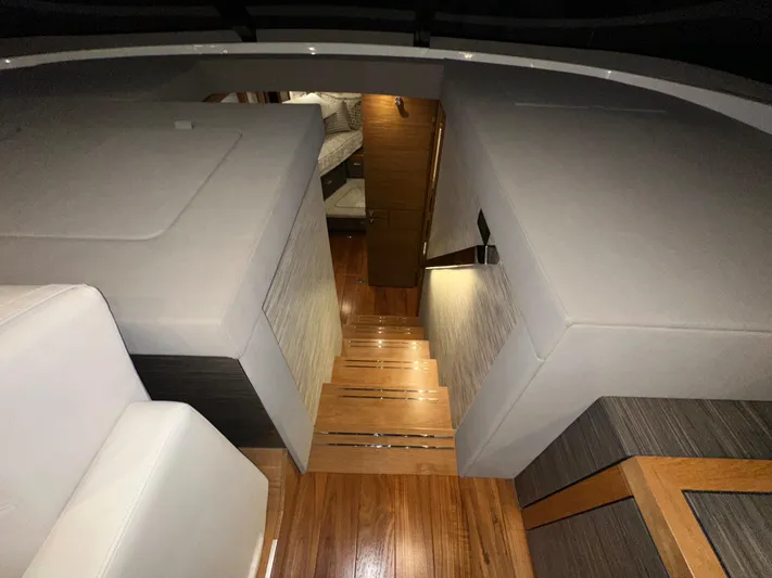 Sapphire Yacht Photos Pics Interior of 2020 Tiara Yachts F53 Flybridge, featuring wooden stairs and modern design.