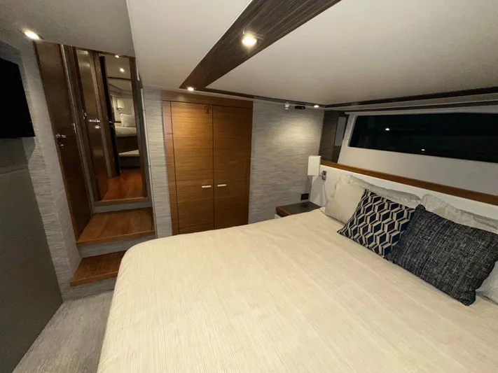 Sapphire Yacht Photos Pics Luxurious bedroom interior of 2020 Tiara Yachts F53 Flybridge with modern design and cozy bedding.