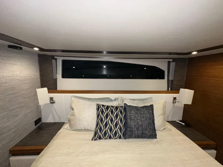 Sapphire Yacht Photos Pics Luxurious bedroom interior of 2020 Tiara Yachts F53 Flybridge with modern design and elegant bedding.