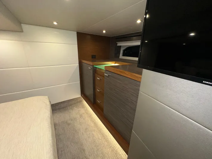 Sapphire Yacht Photos Pics Luxurious interior of 2020 Tiara Yachts F53 Flybridge with modern cabinetry and TV.