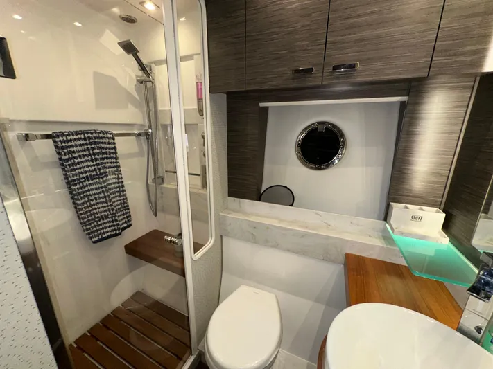 Sapphire Yacht Photos Pics Luxurious bathroom in 2020 Tiara Yachts F53 Flybridge with modern fixtures and wooden accents.