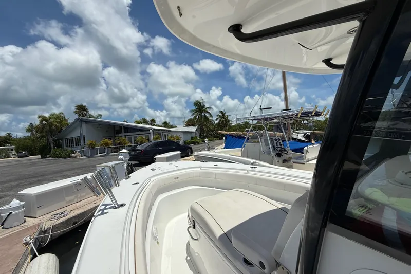 Afterthought Yacht Photos Pics 2022 Sea Hunt Gamefish 30 Coffin Box boat docked under a sunny sky.