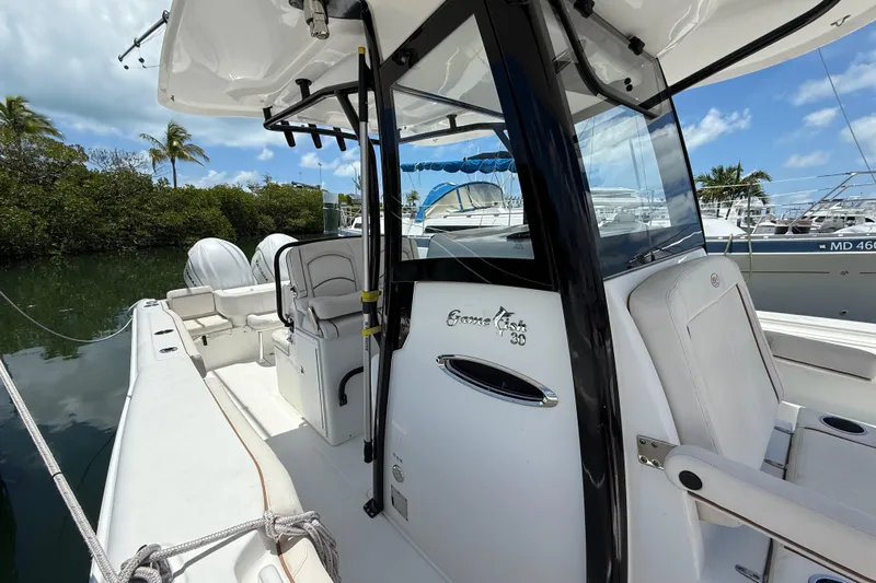 Afterthought Yacht Photos Pics 2022 Sea Hunt Gamefish 30 Coffin Box boat docked, featuring sleek design and comfortable seating.