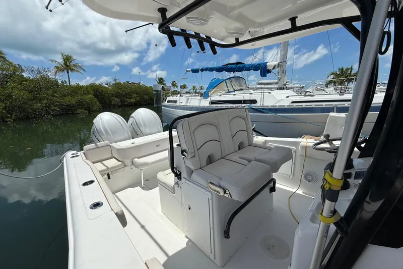 Afterthought Yacht Photos Pics 2022 Sea Hunt Gamefish 30 Coffin Box boat interior with dual engines, docked near yachts.