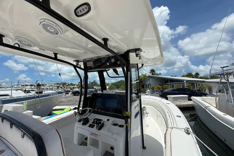 Afterthought Yacht Photos Pics 2022 Sea Hunt Gamefish 30 Coffin Box boat interior with helm and electronics.