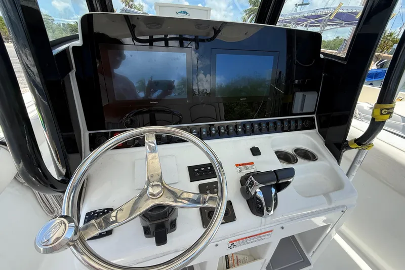 Afterthought Yacht Photos Pics 2022 Sea Hunt Gamefish 30 Coffin Box helm with dual screens and steering wheel.