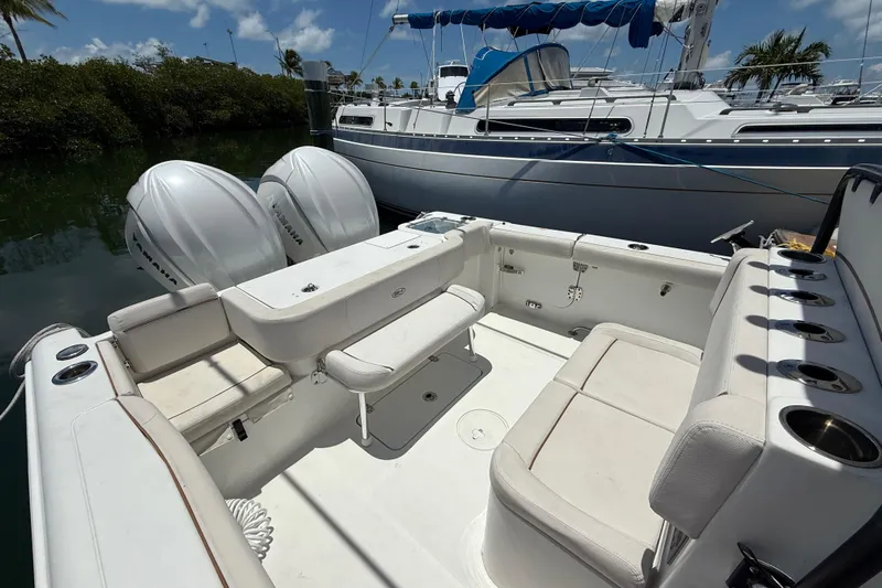 Afterthought Yacht Photos Pics 2022 Sea Hunt Gamefish 30 Coffin Box with dual Yamaha engines, docked near sailboat.